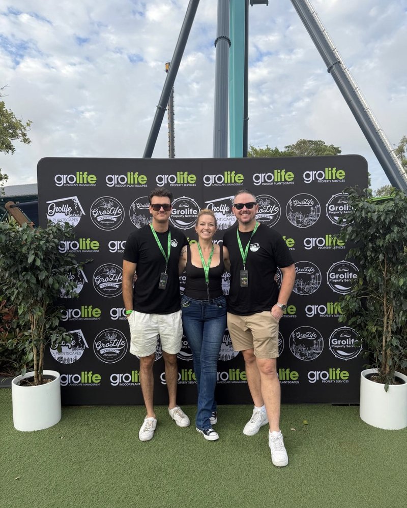 Team at a branded photo backdrop