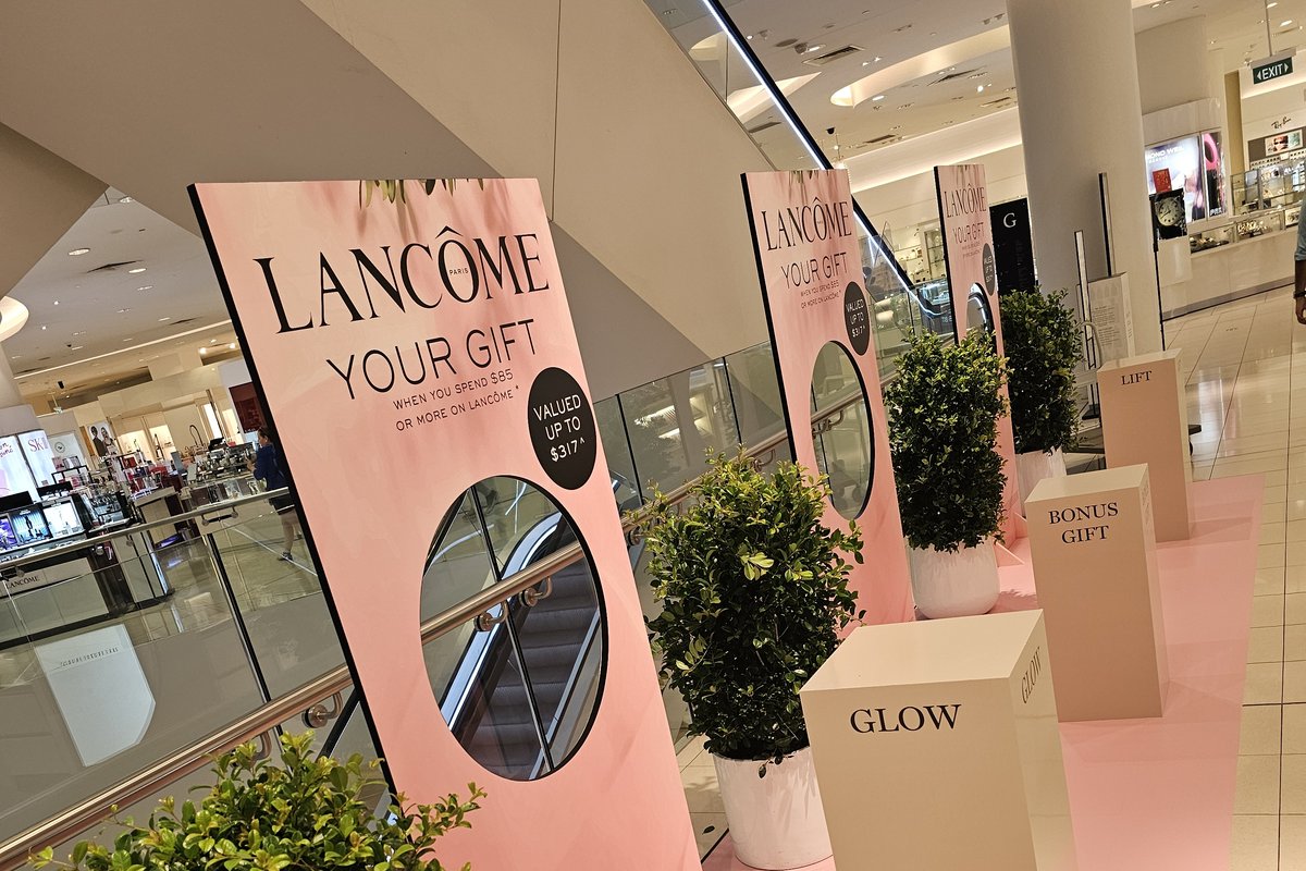 A Lancôme “Your Gift” retail activation styled with topiary trees and plinths by Grolife Indoor Plantscapes