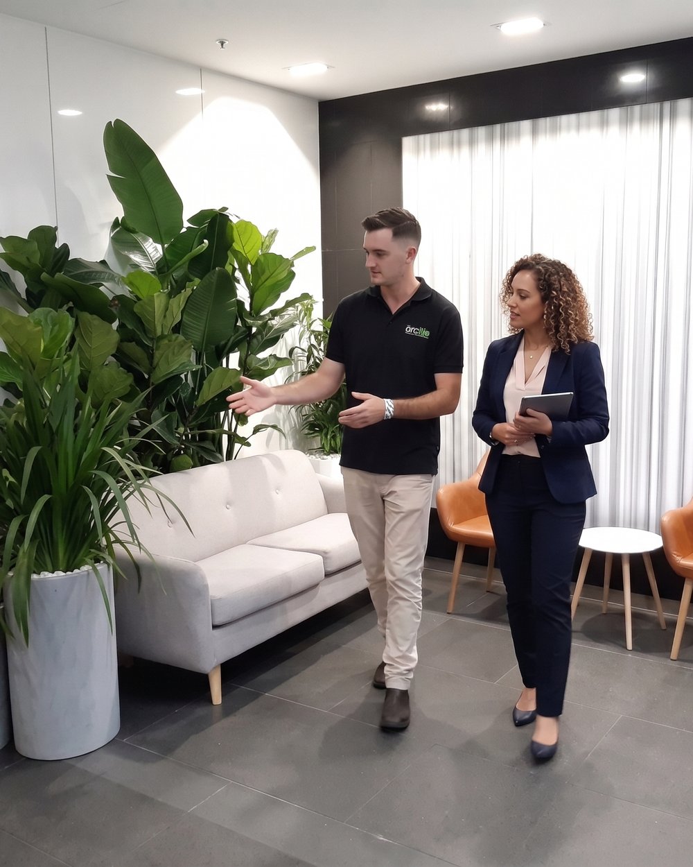 A Grolife Indoor Plantscapes account manager walking through a commercial lobby with a property manager, recommending what to add
