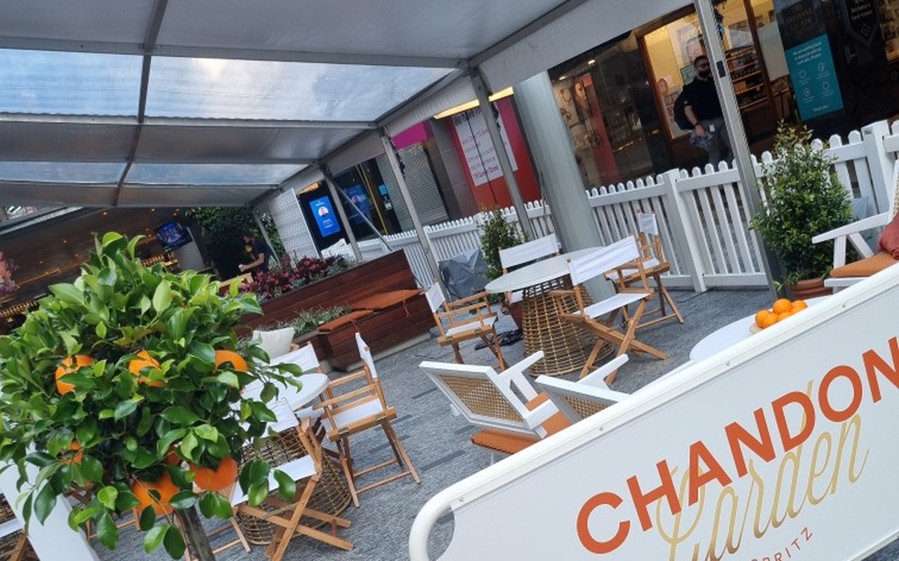A Chandon Garden Spritz pop-up bar styled with topiary trees and fruit baskets — a long-running short-term brand activation by Grolife Indoor Plantscapes